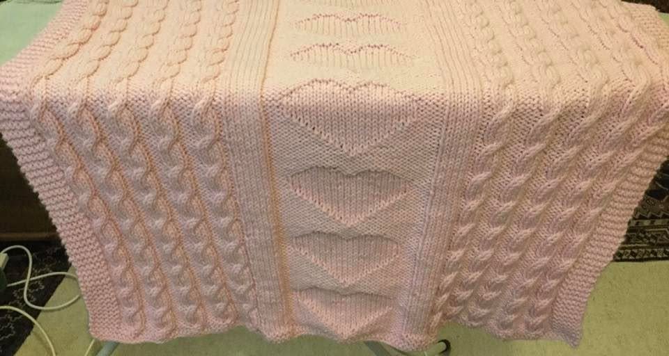 Baby blanket with hearts and cables.